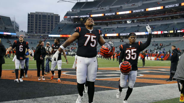 Dec 10, 2023; Cincinnati, Ohio, USA; Cincinnati Bengals offensive tackle Orlando Brown Jr. (75) and cornerback Jalen Davis (35) celebrate the win following the second half against the Indianapolis Colts at Paycor Stadium. Mandatory Credit: Joseph Maiorana-USA TODAY Sports  